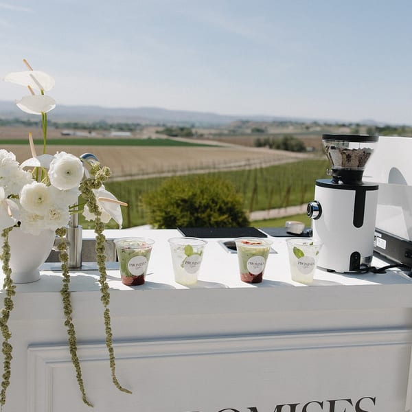 Floral arrangement beside espresso machine
